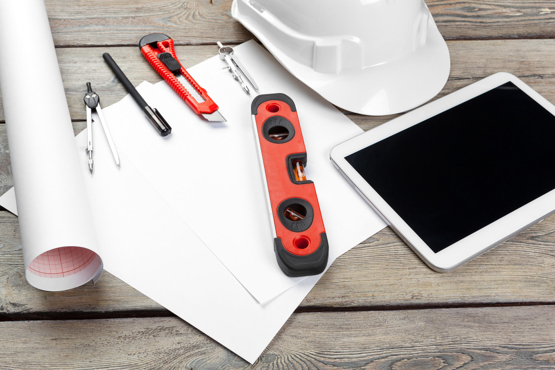 top view of architect workplace with blueprint paper and digital tablet with blank screen